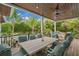 Covered outdoor dining area with wood ceiling, comfortable seating, and views of lush landscaping at 5005 Gulf Of Mexico Dr # 5, Longboat Key, FL 34228