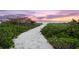 A sandy beach path leads to the ocean at sunset at 5005 Gulf Of Mexico Dr # 5, Longboat Key, FL 34228