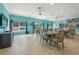 Bright and airy community room with tables, chairs, and a TV at 542 Sutton Pl, Longboat Key, FL 34228