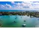 Aerial view of waterfront homes and boats in a peaceful bay at 542 Sutton Pl, Longboat Key, FL 34228