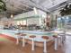 Modern bar with turquoise tile, metal counter, and barstools at 542 Sutton Pl, Longboat Key, FL 34228