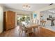 Bright dining room with hardwood floors and view of kitchen at 542 Sutton Pl, Longboat Key, FL 34228