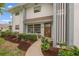 Front entrance with walkway, landscaping, and two chairs at 542 Sutton Pl, Longboat Key, FL 34228