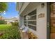 Side entrance with two chairs and potted plants at 542 Sutton Pl, Longboat Key, FL 34228