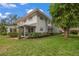 Exterior view of a light blue house with green lawn at 542 Sutton Pl, Longboat Key, FL 34228