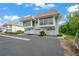 White two-story home with attached garage and landscaping at 542 Sutton Pl, Longboat Key, FL 34228