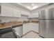 Bright kitchen with stainless steel appliances and white cabinets at 542 Sutton Pl, Longboat Key, FL 34228