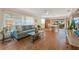 Living room with light teal couch and hardwood floors at 542 Sutton Pl, Longboat Key, FL 34228