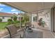 Relaxing screened porch with patio furniture and view of backyard at 542 Sutton Pl, Longboat Key, FL 34228