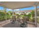 Relaxing screened porch with patio furniture, overlooking a garden at 542 Sutton Pl, Longboat Key, FL 34228