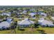 Aerial view of the home's backyard and surrounding neighborhood at 437 Wexford Cir # 79, Venice, FL 34293