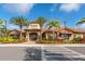 Community clubhouse with palm trees at 12720 Sorrento Way # 102, Bradenton, FL 34211