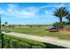 Scenic driving range with golf carts and beautiful homes in the background at 12720 Sorrento Way # 102, Bradenton, FL 34211