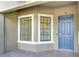 Inviting entryway with a blue door and a large window at 12720 Sorrento Way # 102, Bradenton, FL 34211