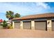 Three-car garage with paved driveway and landscaping at 12720 Sorrento Way # 102, Bradenton, FL 34211