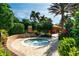 Enjoy a relaxing soak in this hot tub surrounded by lush landscaping at 12720 Sorrento Way # 102, Bradenton, FL 34211