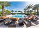 Resort-style pool with lounge chairs and palm trees at 12720 Sorrento Way # 102, Bradenton, FL 34211