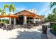 Relaxing poolside bar with tables and orange umbrellas at 12720 Sorrento Way # 102, Bradenton, FL 34211