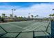 Tennis court with surrounding fence and palm trees at 12720 Sorrento Way # 102, Bradenton, FL 34211