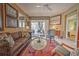 Living room with access to the patio, featuring seating and a rug at 8047 Victoria Falls Cir, Sarasota, FL 34243