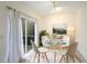 Charming dining area with glass table and white chairs at 7632 Plantation Cir, Bradenton, FL 34201