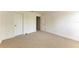 Bedroom featuring neutral carpet and white walls, with a door and an entrance to another room at 3411 Clark Rd # 212, Sarasota, FL 34231