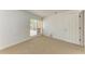 Bedroom featuring neutral carpet, white walls, a window with blinds, and a door at 3411 Clark Rd # 212, Sarasota, FL 34231