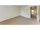 Bedroom featuring neutral carpet and white walls, with an entrance to another room at 3411 Clark Rd # 212, Sarasota, FL 34231