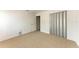 A neutral carpeted bedroom with modern closet and a freshly painted white walls at 3411 Clark Rd # 212, Sarasota, FL 34231