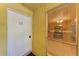 Condo unit entrance with the door, unit number 212, exterior stucco, and partially visible kitchen through window at 3411 Clark Rd # 212, Sarasota, FL 34231