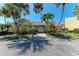 Charming exterior of a home with lush landscaping and palm trees on a sunny day at 3411 Clark Rd # 212, Sarasota, FL 34231