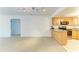 Open floor plan from the living room to the kitchen, featuring carpet and tile flooring at 3411 Clark Rd # 212, Sarasota, FL 34231