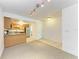 Open floor plan from the living room to the kitchen, featuring tile and carpet flooring at 3411 Clark Rd # 212, Sarasota, FL 34231