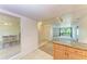 Living room with a view into the dining area, featuring an entry closet and balcony at 3411 Clark Rd # 212, Sarasota, FL 34231