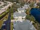 Aerial view of villas and parking near a lake at 4629 Whirlaway Dr # B, Sarasota, FL 34233