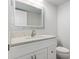 Bright bathroom boasts a white vanity and quartz countertop at 4629 Whirlaway Dr # B, Sarasota, FL 34233