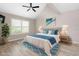 Main bedroom with plush bed, wood-look floors, and a ceiling fan at 4629 Whirlaway Dr # B, Sarasota, FL 34233