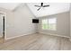 Spacious bedroom featuring a ceiling fan and wood-look floors at 4629 Whirlaway Dr # B, Sarasota, FL 34233