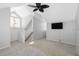 Open loft area with a ceiling fan and wall-mounted TV at 4629 Whirlaway Dr # B, Sarasota, FL 34233