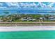 Stunning beachside property featuring turquoise waters and luxury homes nestled amongst lush green foliage and white sandy beaches at 709 Bayport Way # 709, Longboat Key, FL 34228