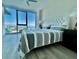 Bright bedroom with water views and plush bedding at 1155 N Gulfstream Ave # 406, Sarasota, FL 34236