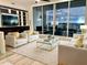 Elegant living room with city view, featuring plush seating and a modern coffee table at 1155 N Gulfstream Ave # 406, Sarasota, FL 34236