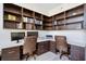 Spacious home office with built-in shelving and two desks at 1155 N Gulfstream Ave # 406, Sarasota, FL 34236