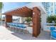 Covered outdoor kitchen with bar seating and grill at 1155 N Gulfstream Ave # 406, Sarasota, FL 34236