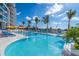 Resort-style pool with comfortable lounge chairs and umbrellas at 1155 N Gulfstream Ave # 406, Sarasota, FL 34236