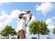 Iconic statue of a sailor kissing a nurse, set against a bright blue sky with fluffy white clouds at 1155 N Gulfstream Ave # 406, Sarasota, FL 34236