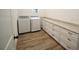 Bright laundry room with white cabinets and granite countertops at 8233 Givlic Ln, North Port, FL 34287
