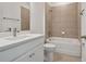 Bathroom with tub and shower combination, white vanity, and neutral tile at 19642 Fort King Run, Brooksville, FL 34601