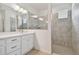 Bathroom with single vanity, large mirror, and shower at 19642 Fort King Run, Brooksville, FL 34601