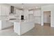 Bright kitchen boasts white cabinets, stainless steel appliances, and an island at 19642 Fort King Run, Brooksville, FL 34601